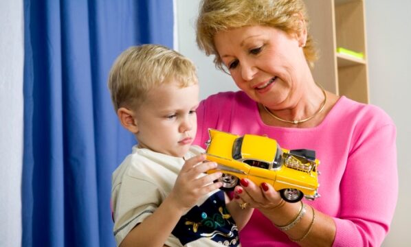 Raising Grandchildren Can Lead to Financial Challenges- Boy and woman holding toy car