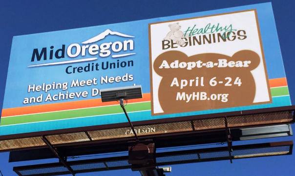 2015 Adopt-a-Bear Effort Raises $2,034 for Healthy Beginnings- Mid Oregon Credit Union Billboard in Bend Showing Amount Raised for Healthy Beginnings