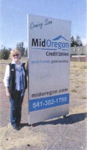 La Pine Chamber's Ann Gawith with the Mid Oregon sign