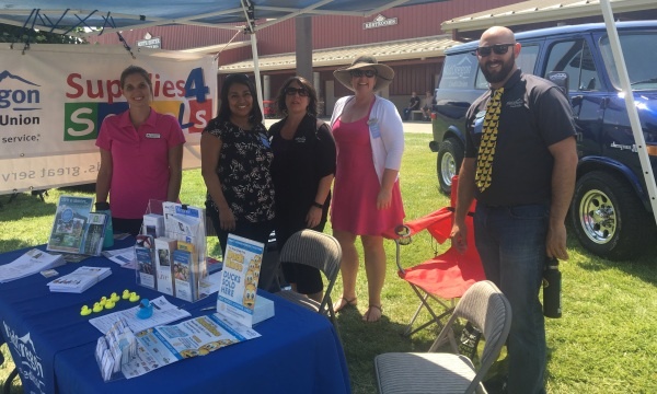 Friday at the Deschutes County Fair- Fair booth with tables and Mid Oregon staff