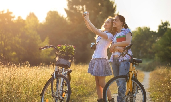 Budgeting For College Expenses -Two Female College Students on Bicycles on Rural Path