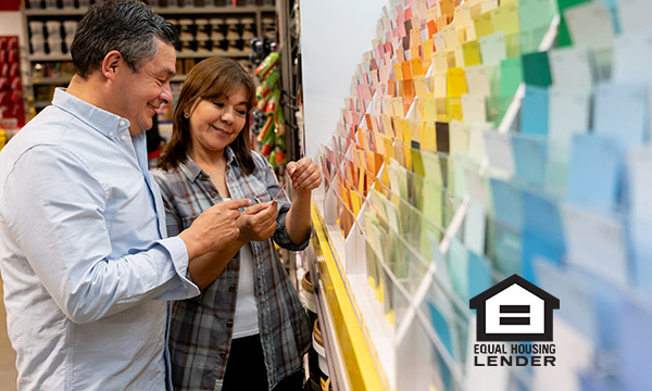 Couple choosing paint colors at home store