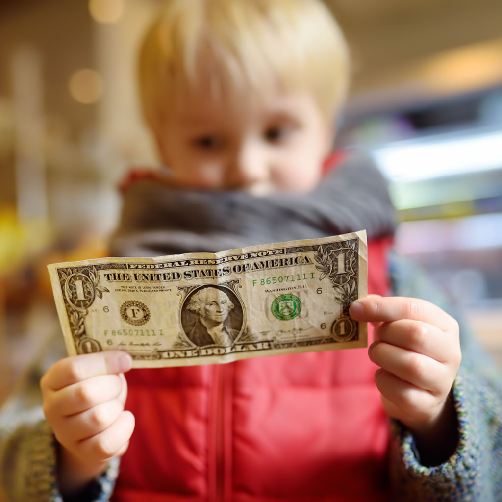 How Financially Literate is your Child? | Boy looking at dollar