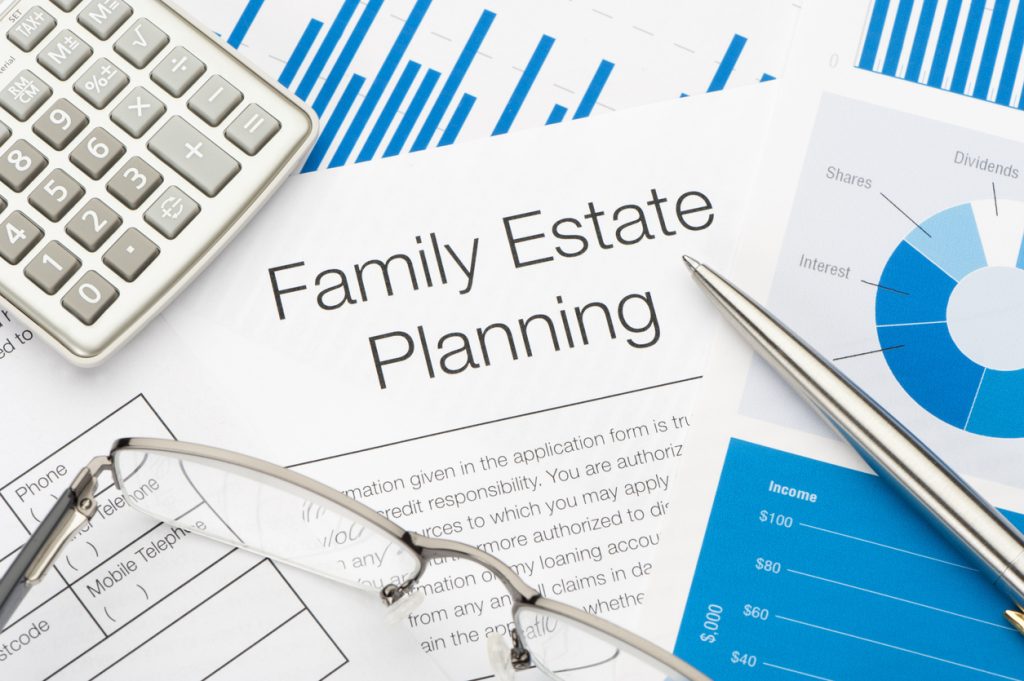 Why is Estate Planning Important? | Picture of Family Estate Planning documents with pen, calculator and reading glasses.